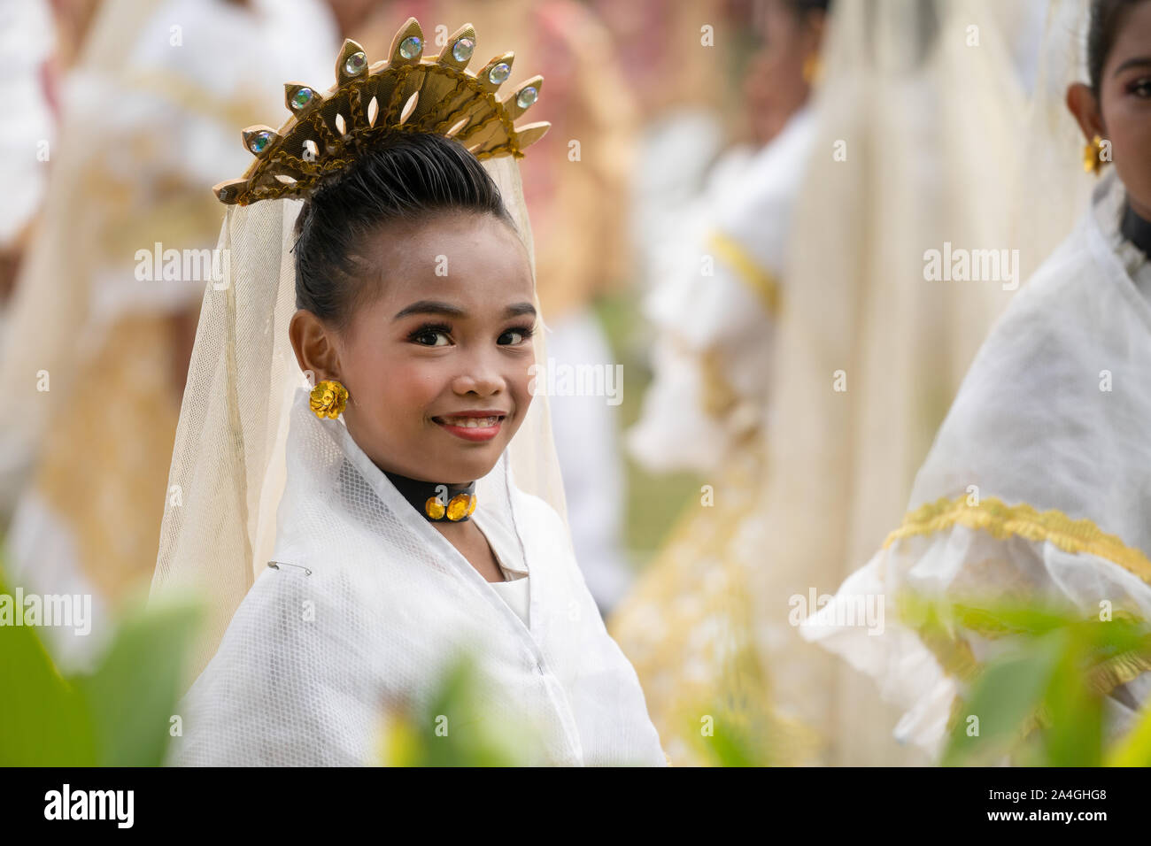 A young girl taking partin a local street dancing parade smiles at the camera as her picture is taken. Stock Photo