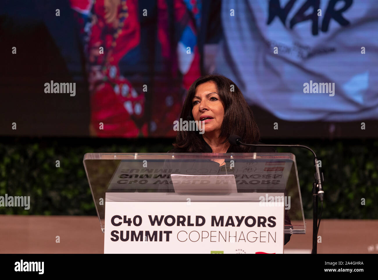 COPENHAGEN, DENMARK -  OCTOBER 10, 2019: Anne Hidalgo, Mayor of Paris and Chair of the C40, during her hand-over speech of the Chair to Eric Garcetti, Mayor of Los Angeles, at the C40 World Mayors Summit 2019 in Copenhagen. More than 70 mayors of some of the world’s largest and most influential cities representing some 700 million people meet in Copenhagen from October 9-12 for the C40 World Mayors Summit. The purpose with the summit in Copenhagen is to build a global coalition of leading cities, businesses and citizens that rallies around radical and ambitious climate action. Also youth leade Stock Photo