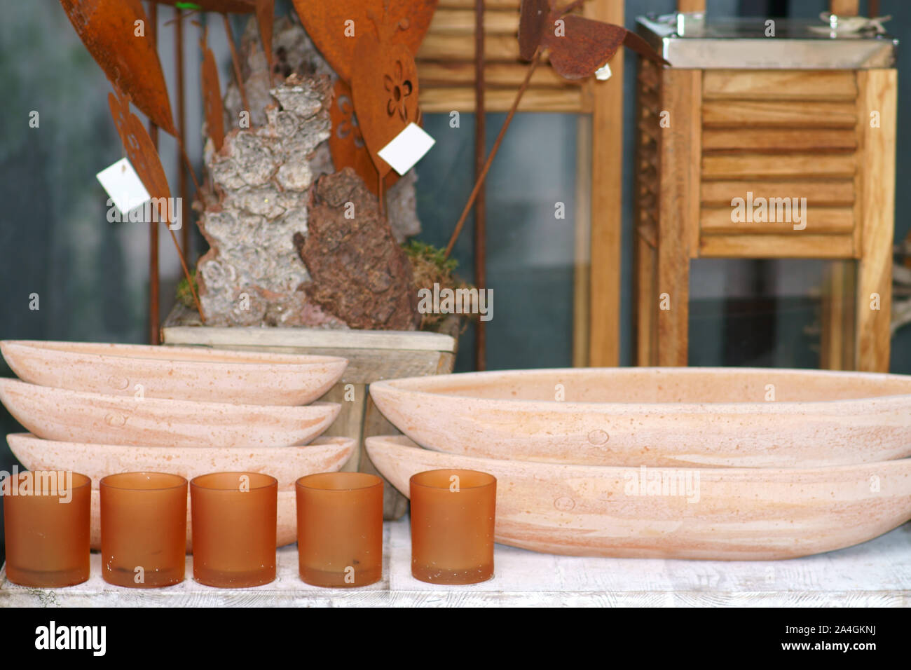 Various clay bowls or bowls made of terracotta on a sales stall with artisanal objects. Stock Photo