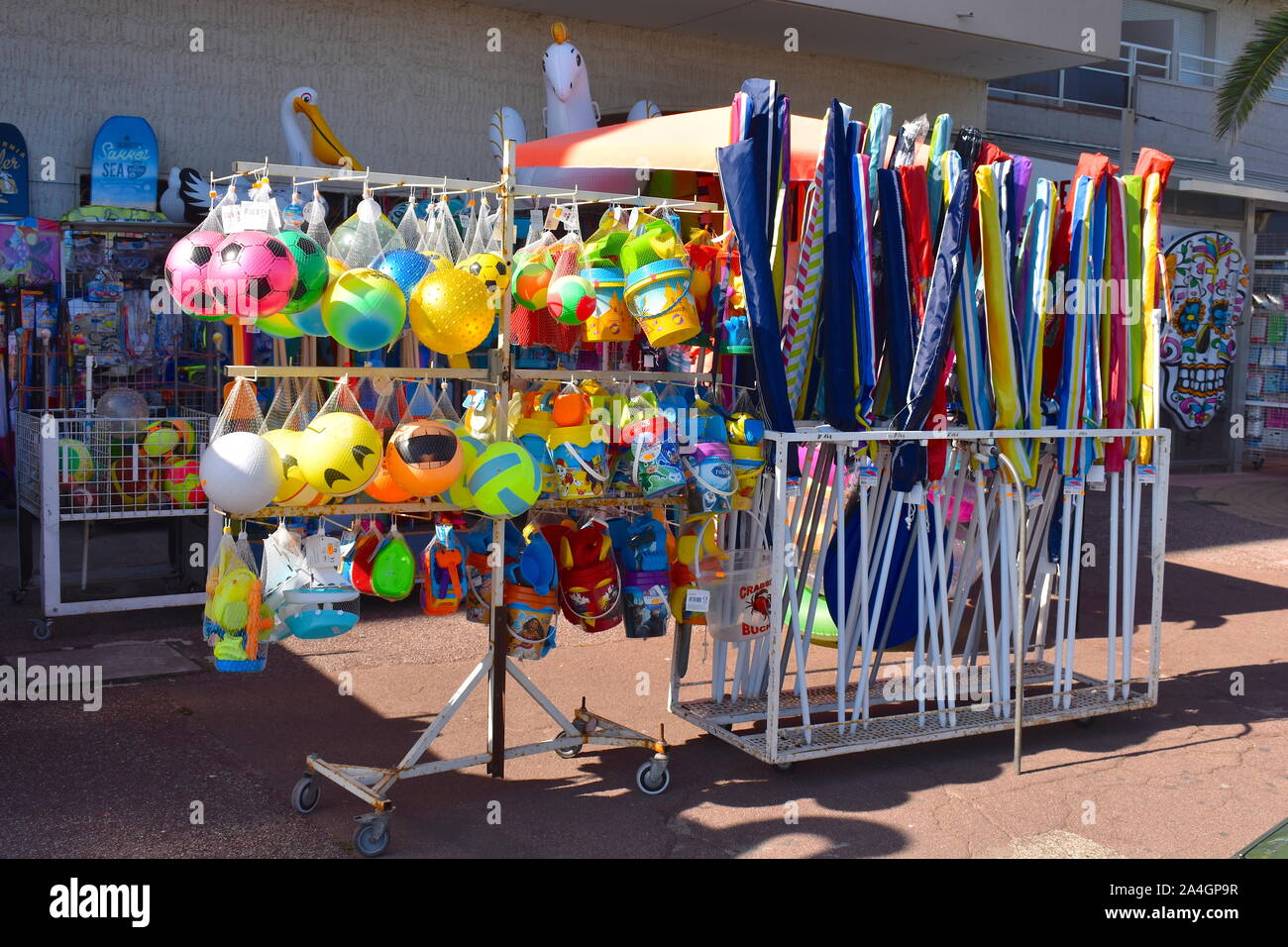 Bucket, spade and mould sets, beach balls, beach tennis, swimming inflatables and body boards sold on the promenade in south of France. Stock Photo