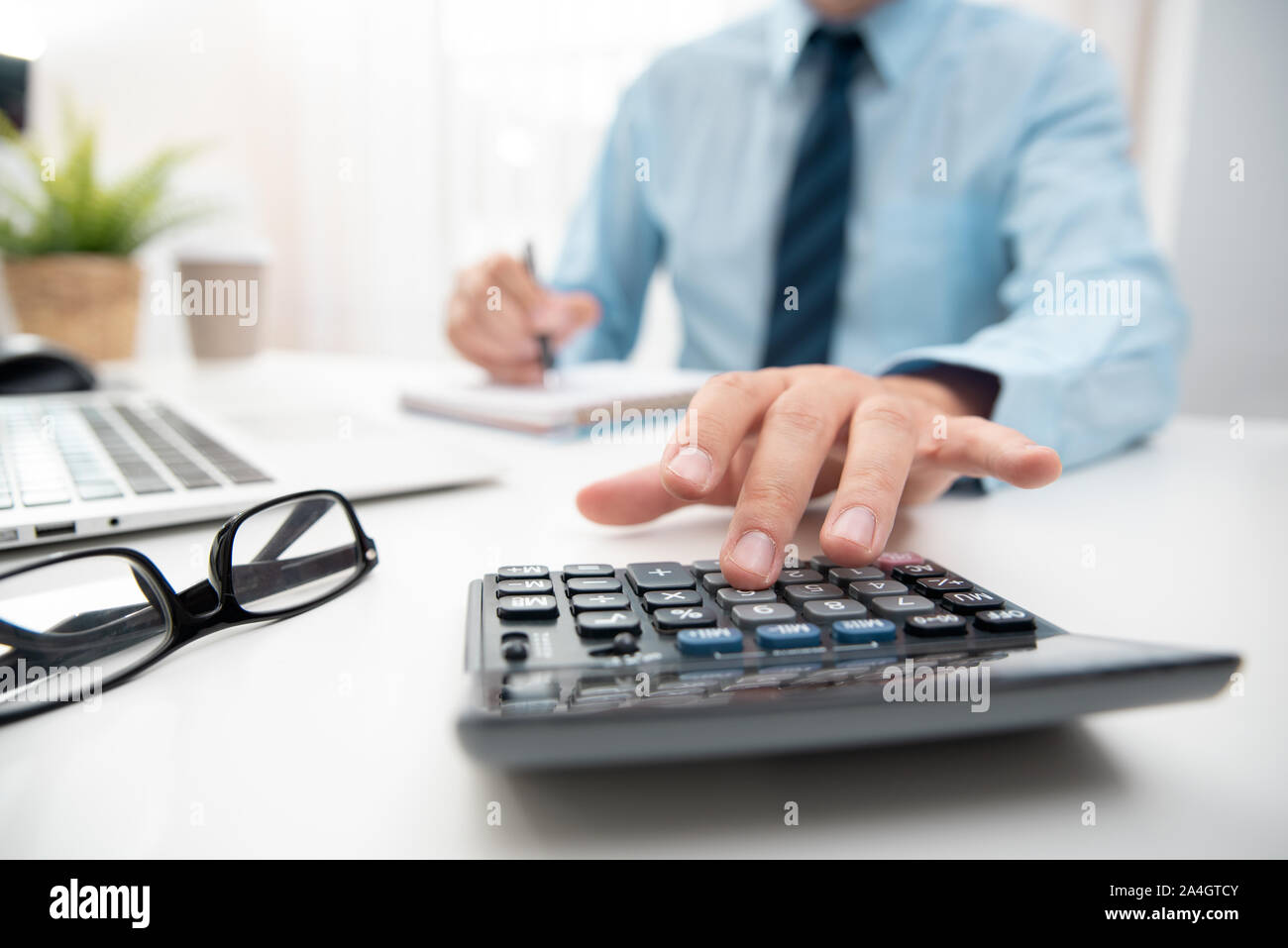 Accountant calculate tax information or business data. Businessman working in office Stock Photo