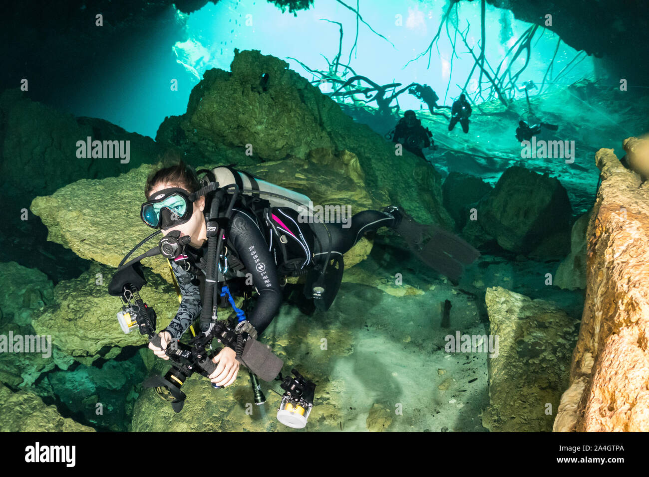 A scuba diver swims into the entrance of Car Wash cenote in Mexico's Yucatan Peninsula. Stock Photo