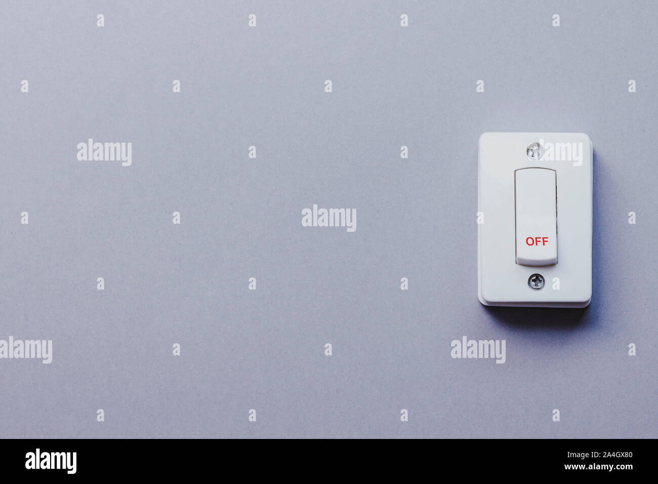 Light switch on the grey wall. On and Off switch. Saving energy concept