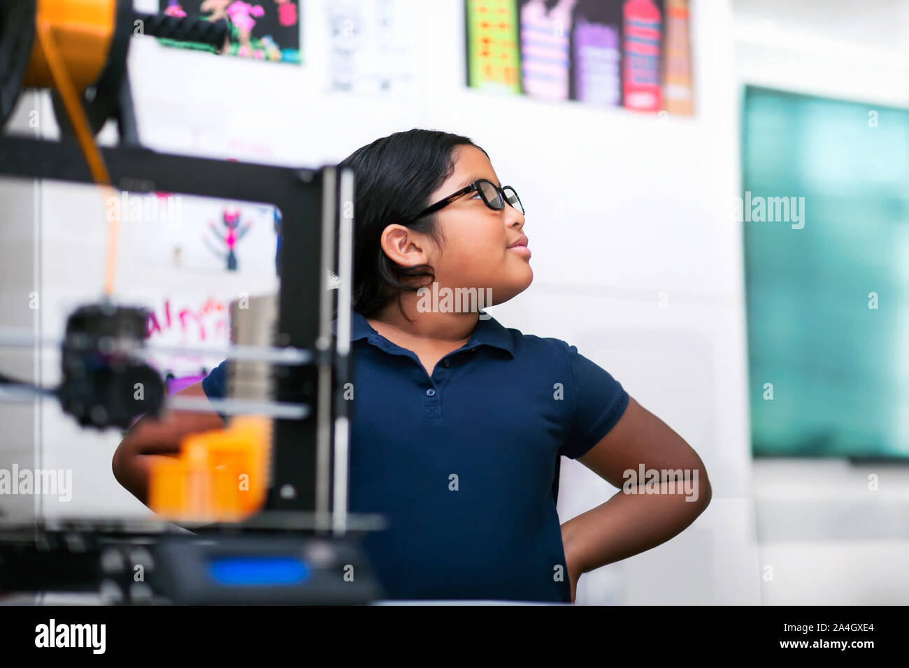 A confident latino student thinking about her 3D project in a after school program focusing on STEM. Stock Photo