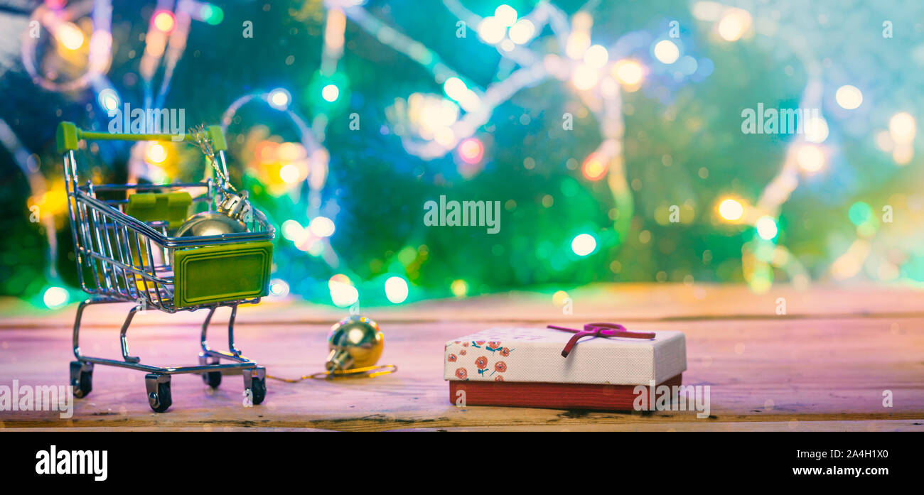 Shopping cart full of presents. Christmas gifts shopping. Online shopping, Black Friday and Ciber Monday concepts. Trolley cart with gifts. Copy space Stock Photo