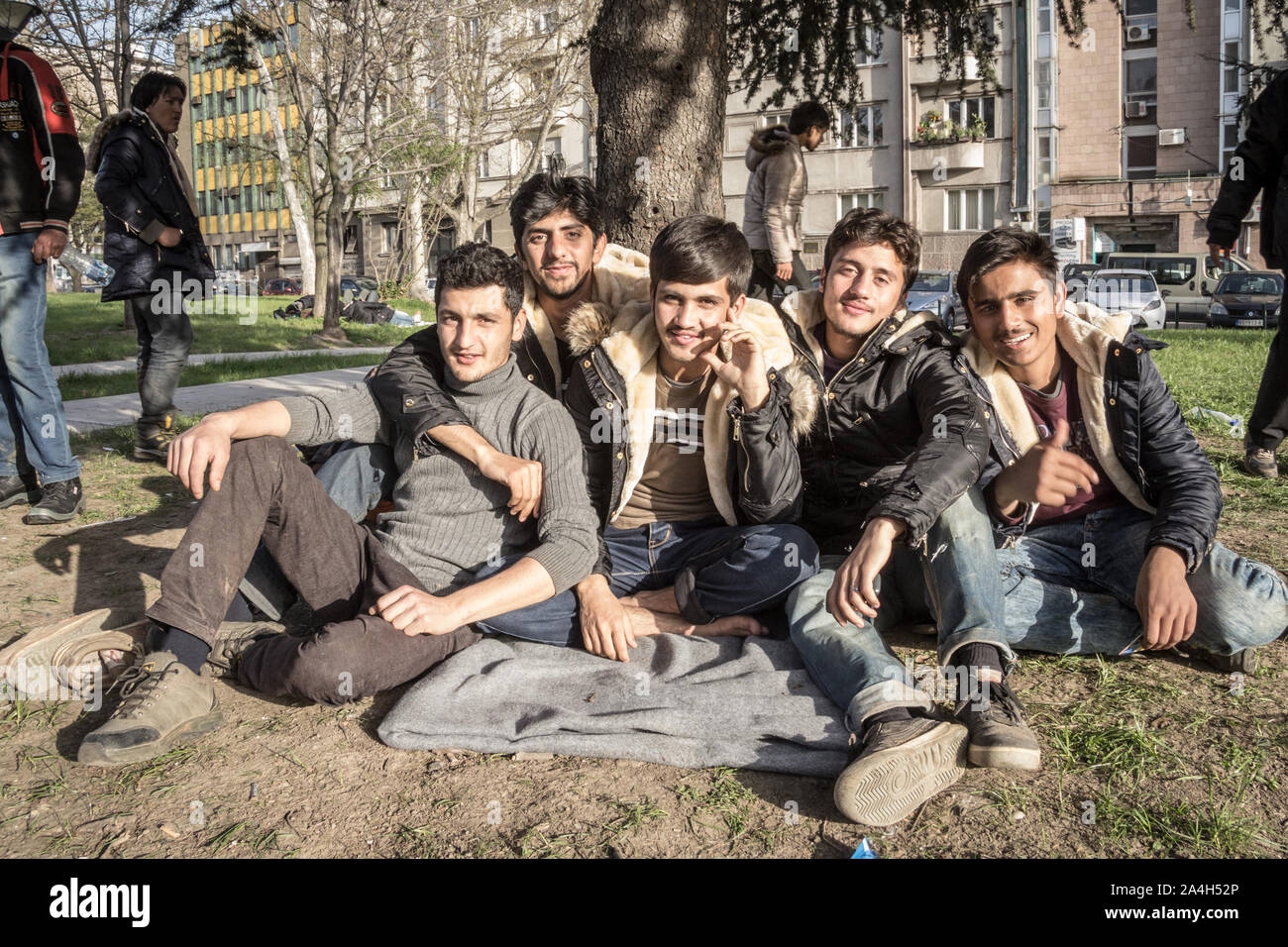 BELGRADE, SERBIA - APRIL 2, 2016: Refugees, young men from Syria and Afghanistan, sitting & posing in a Belgrade park, being in transit towards the Eu Stock Photo