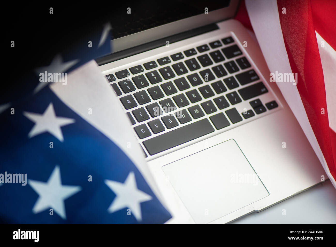 US flag and laptop on white background with copy space wallpaper Stock Photo
