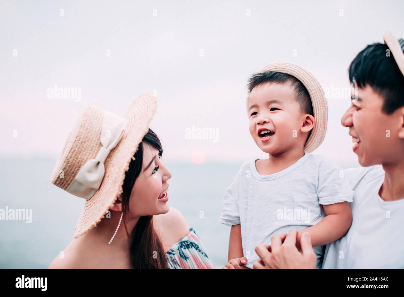 Young asian family on the beach hi-res stock photography and images - Alamy