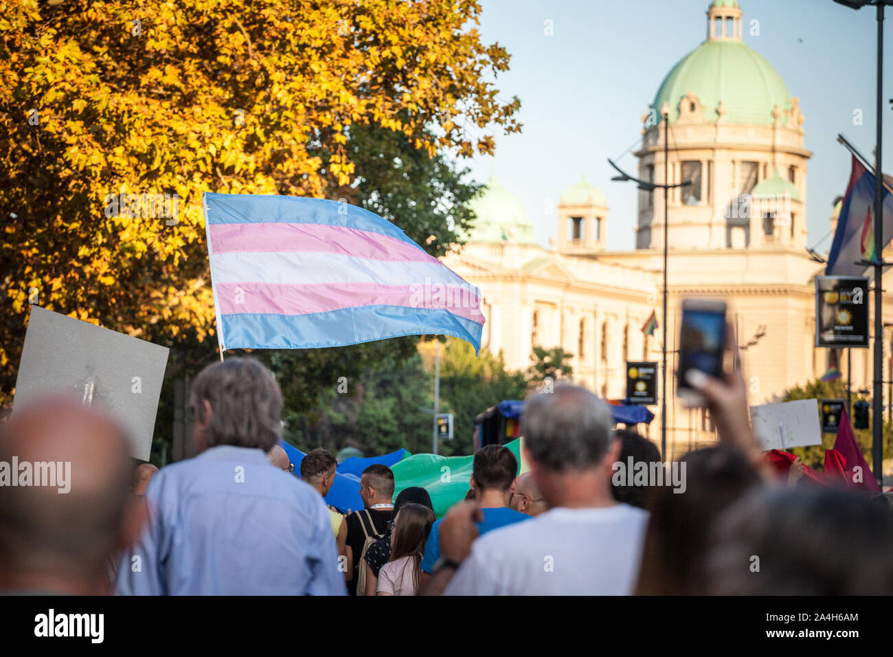BELGRADE, SERBIA - SEPTEMBER 15, 2019:  Transgender pride flag waiving and standing above the crowd during the Belgrade Gay Pride. The parade happened Stock Photo
