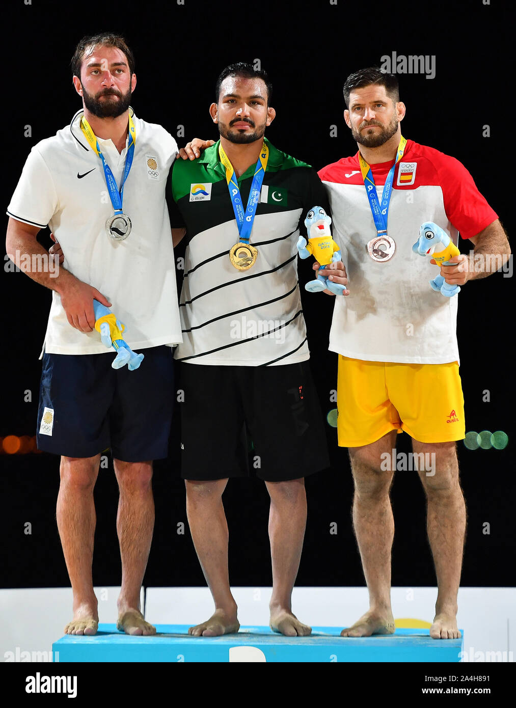 Doha, Qatar. 14th Oct, 2019. Gold medalist Muhammad Inam (C) of Pakistan, silver medalist Dato Marsagishvili (L) of Georgia and bronze medalist Pedro Jacinto Garcia Perez of Spain pose for photos during the awarding ceremony of the men's Beach Wrestling 90KG at the 1st ANOC World Beach Games Qatar 2019 in Doha, capital of Qatar, on Oct. 14, 2019. Credit: Nikku/Xinhua/Alamy Live News Stock Photo