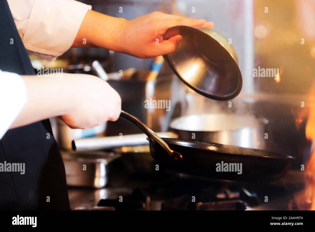 Chef cooking food in the kitchen, Chef preparing food Stock Photo - Alamy