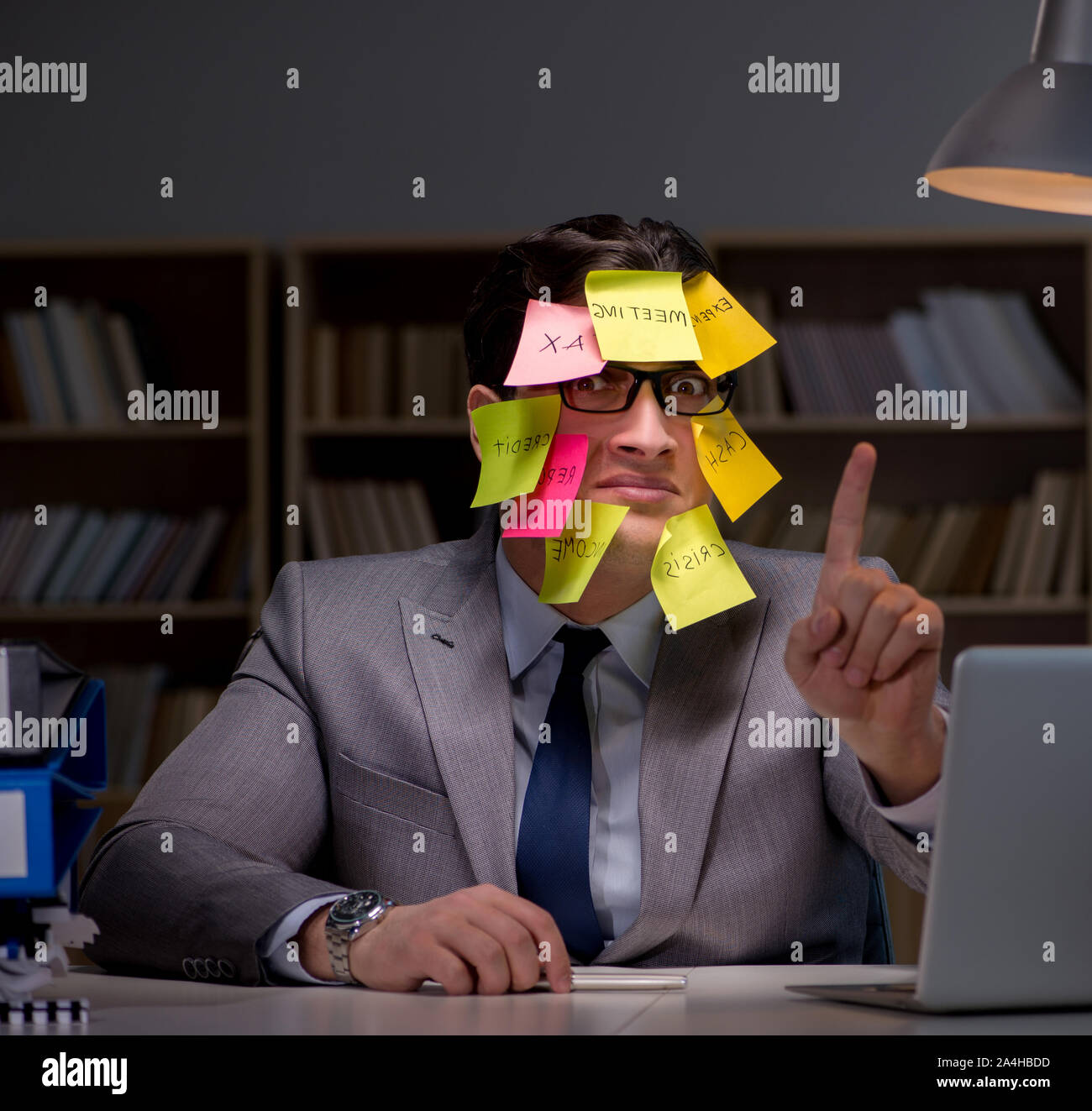 To Sort Out The businessman staying late to sort out priorities Stock Photo - Alamy