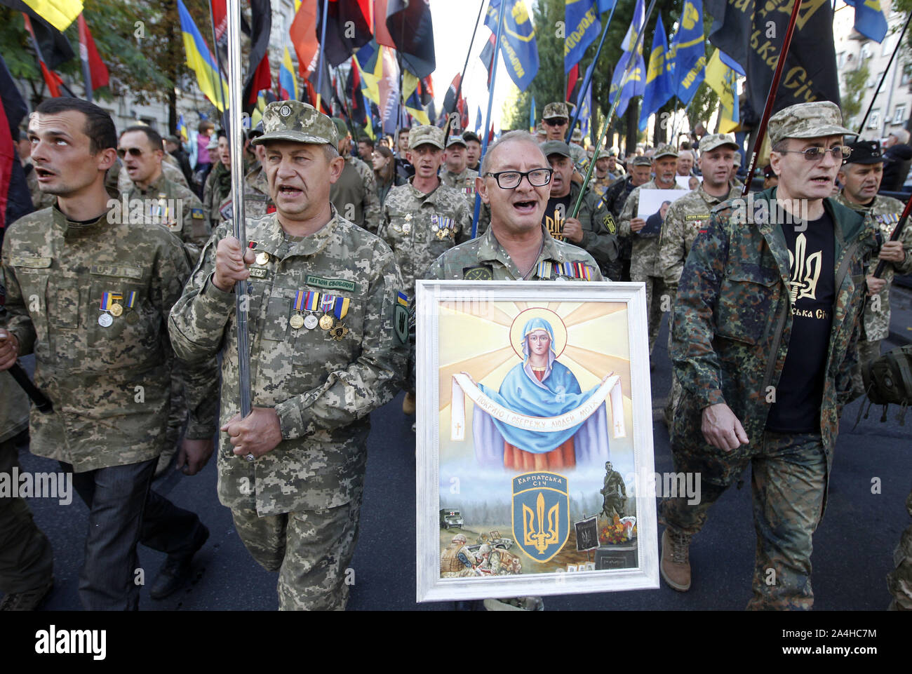 Kiev, Ukraine. 14th Oct, 2019. Ukrainian veterans who participated at the war conflict with pro-Russian separatist shout slogans during a march to celebrate the 77th anniversary of the founding of the Ukrainian Insurgent Army in Kiev, Ukraine, 14 October 2019. The Ukrainian Insurgent Army active fought for Ukrainian independence from 1942 to 1949, mostly in Western Ukraine, against the German and Soviet regimes. Credit: Serg Glovny/ZUMA Wire/Alamy Live News Stock Photo