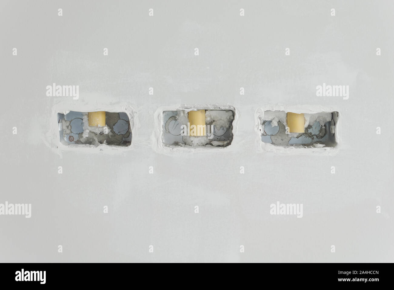 Junction boxes for switches on concrete wall at construction site Stock