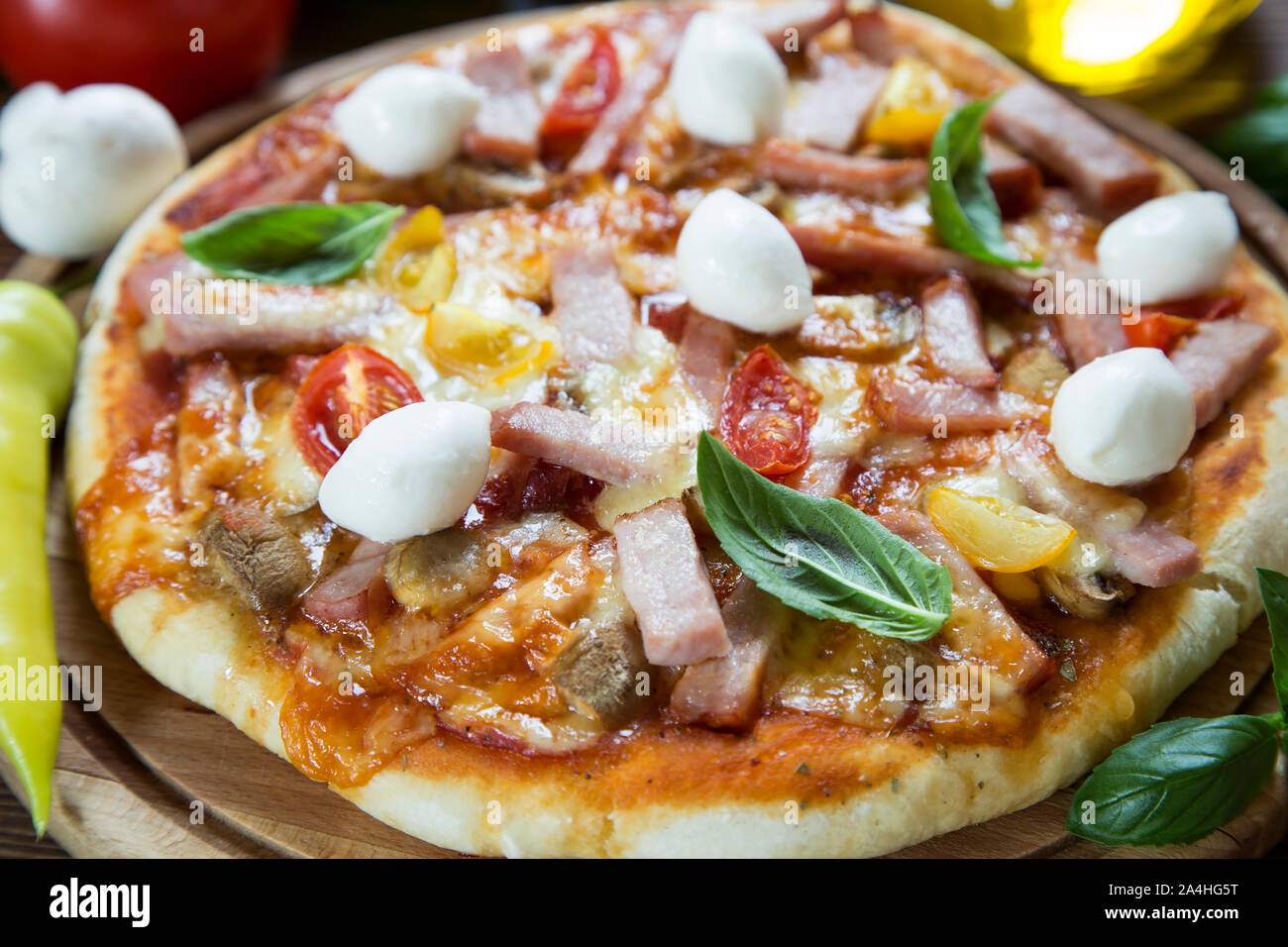Rustic homemade pizza on wooden board Stock Photo - Alamy
