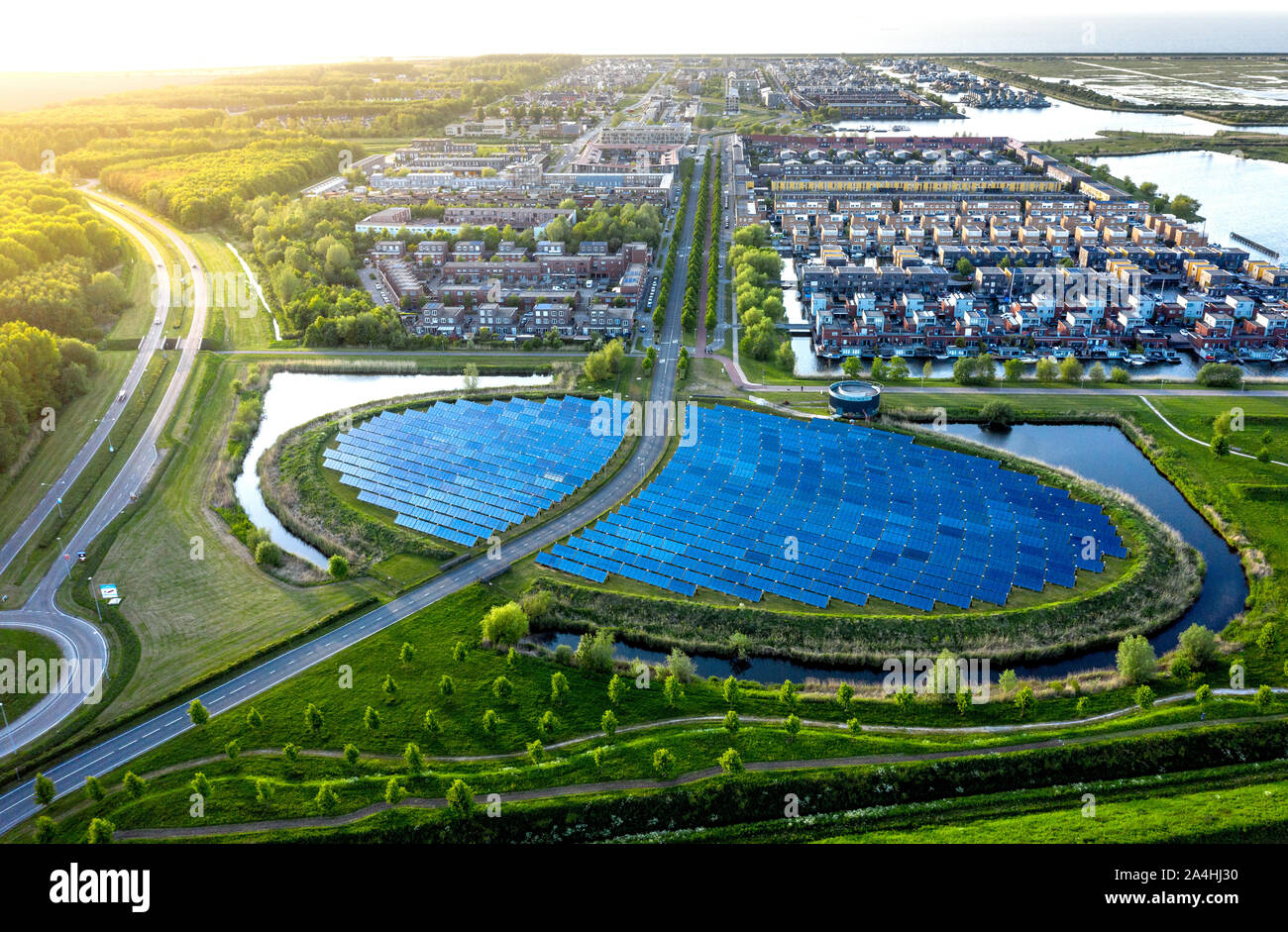 Modern sustainable neighbourhood in Almere, The Netherlands. The city heating (stadswarmte) in the district is partially powered by a solar panel isla Stock Photo