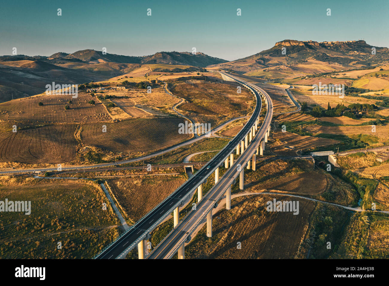 Aerial shot of a highway viaduct/bridge located in a beautiful landscape of Sicily, Italy Stock Photo