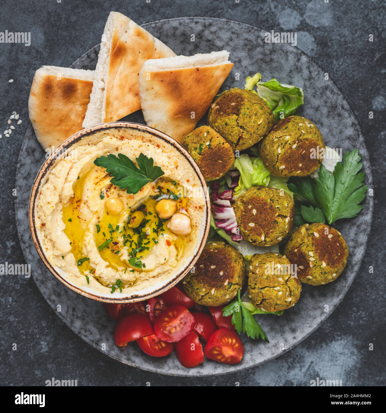 Hummus with falafel and pita bread on plate. Arabic cuisine appetizer