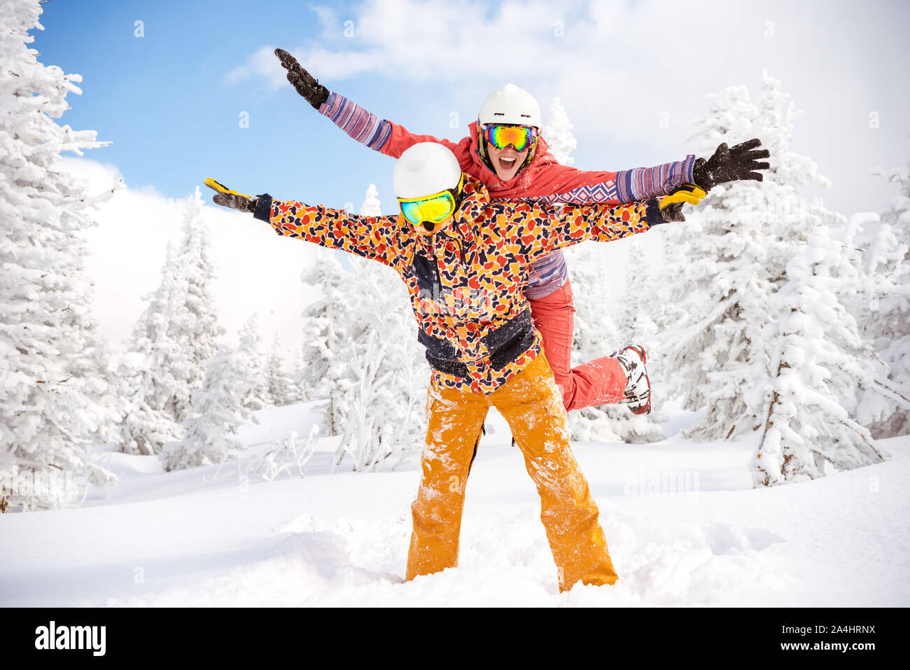 Happy couple skier and snowboarder are having fun at ski resort. Ski winter sports concept Stock Photo