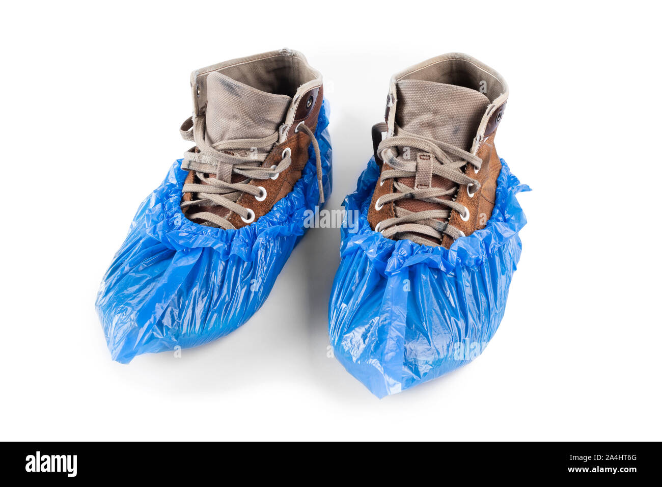 men's shoes in blue plastic shoe covers on a white background