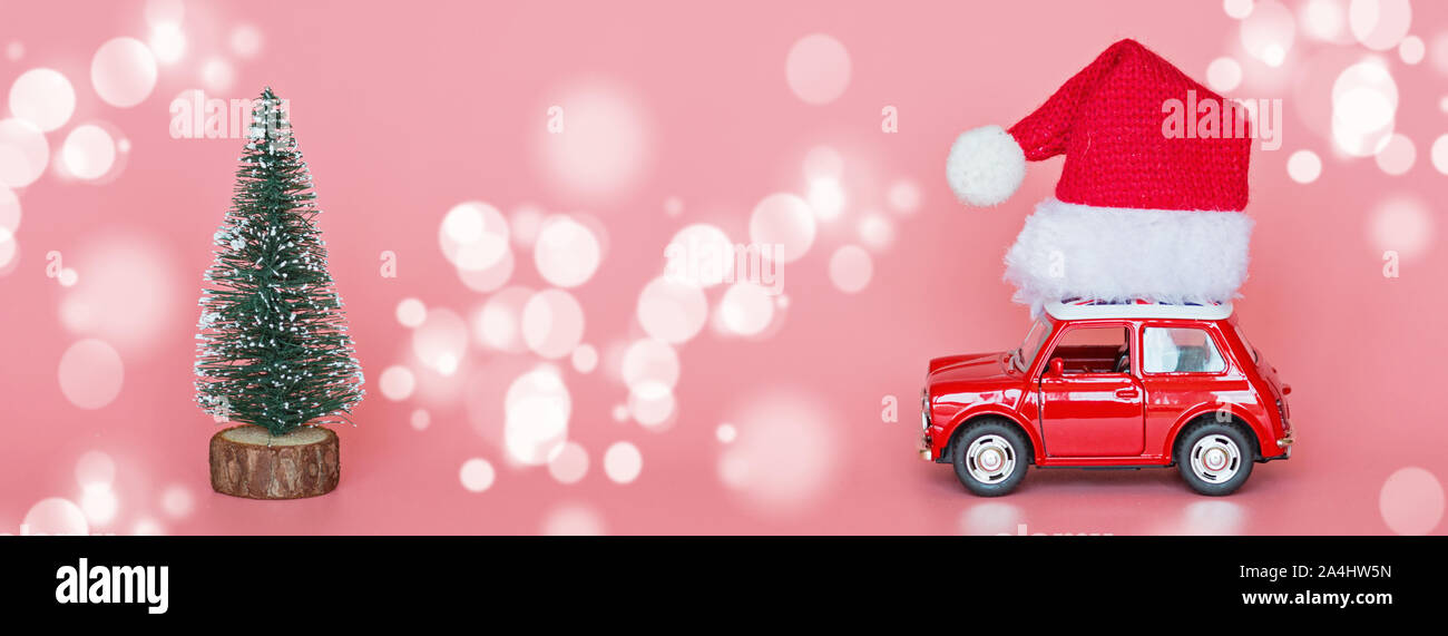 Red toy car with a santa hat, next 