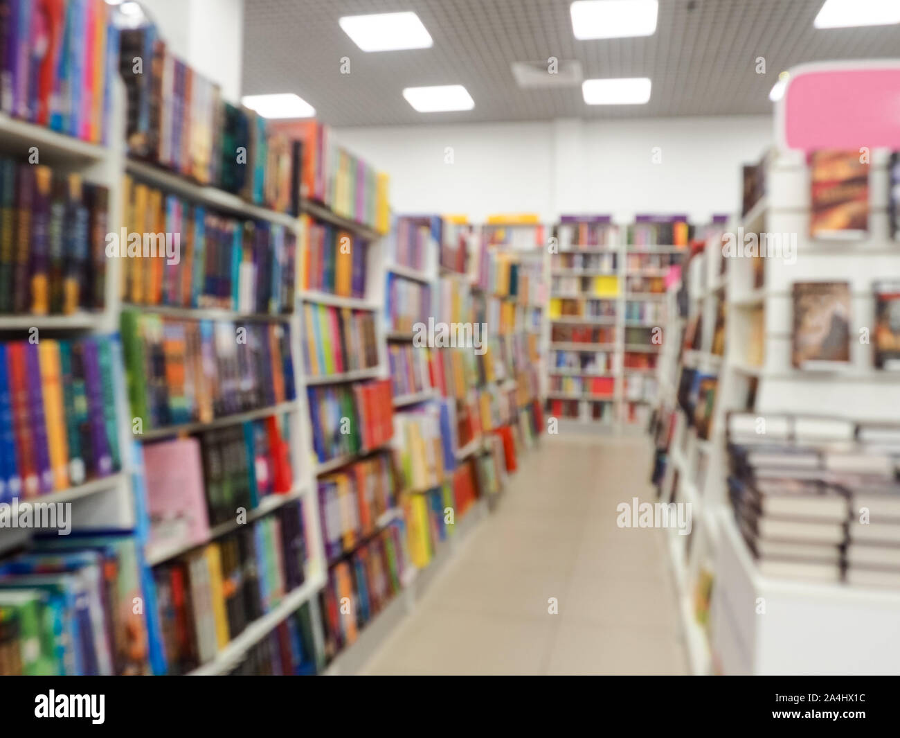 Blurred books on the shelf in public library. Blurred effect Stock Photo