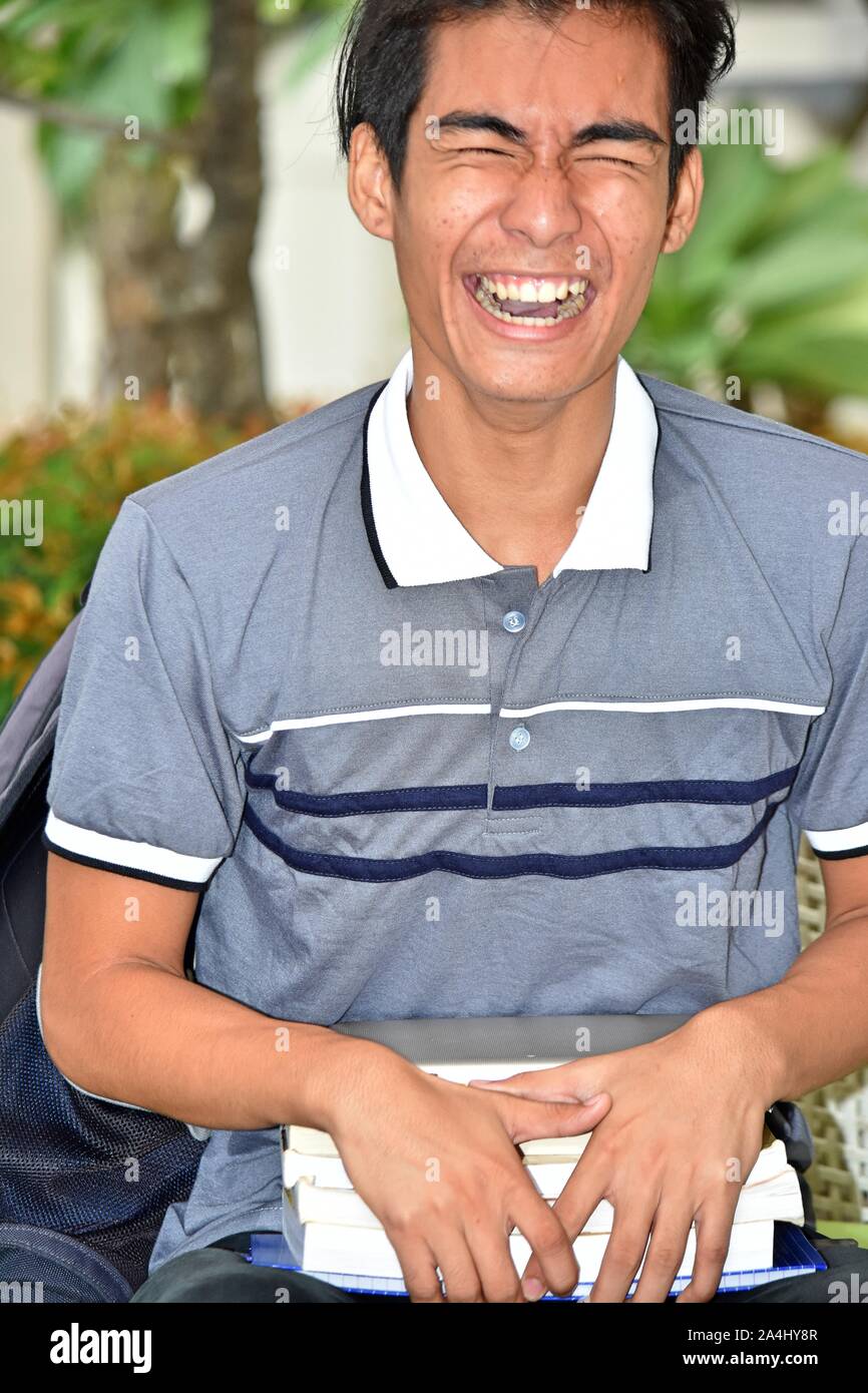 Boy Student Laughing With Books Stock Photo - Alamy