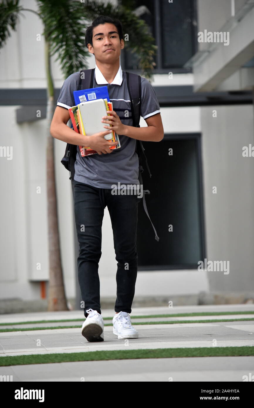 Serious Minority Person With Notebooks Walking Stock Photo - Alamy