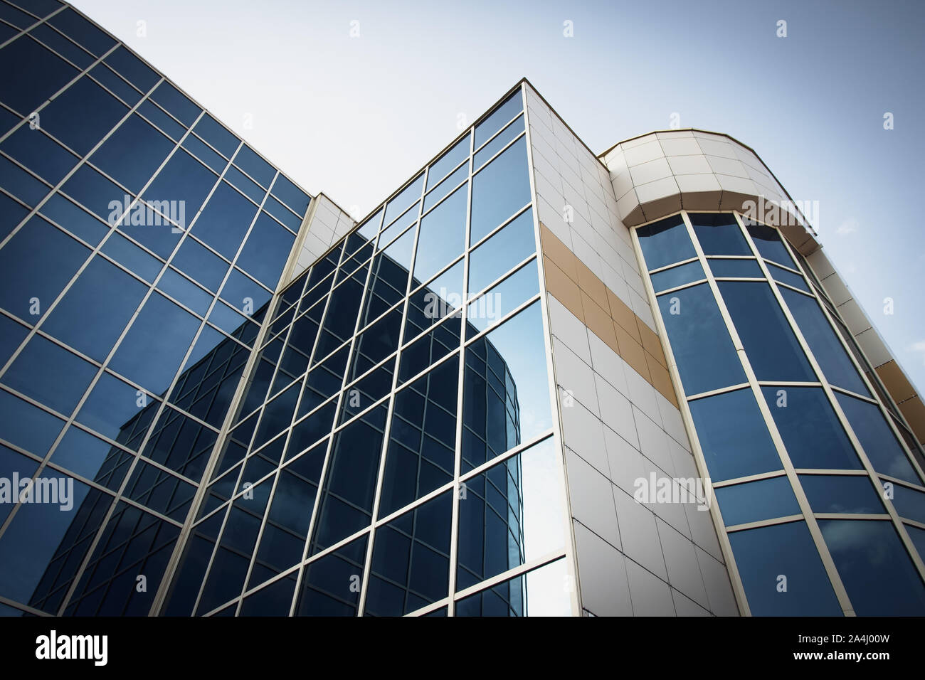 Blue skyscraper. Modern high-rise, reflection texture, facade background. Business center with blue windows. Stock Photo