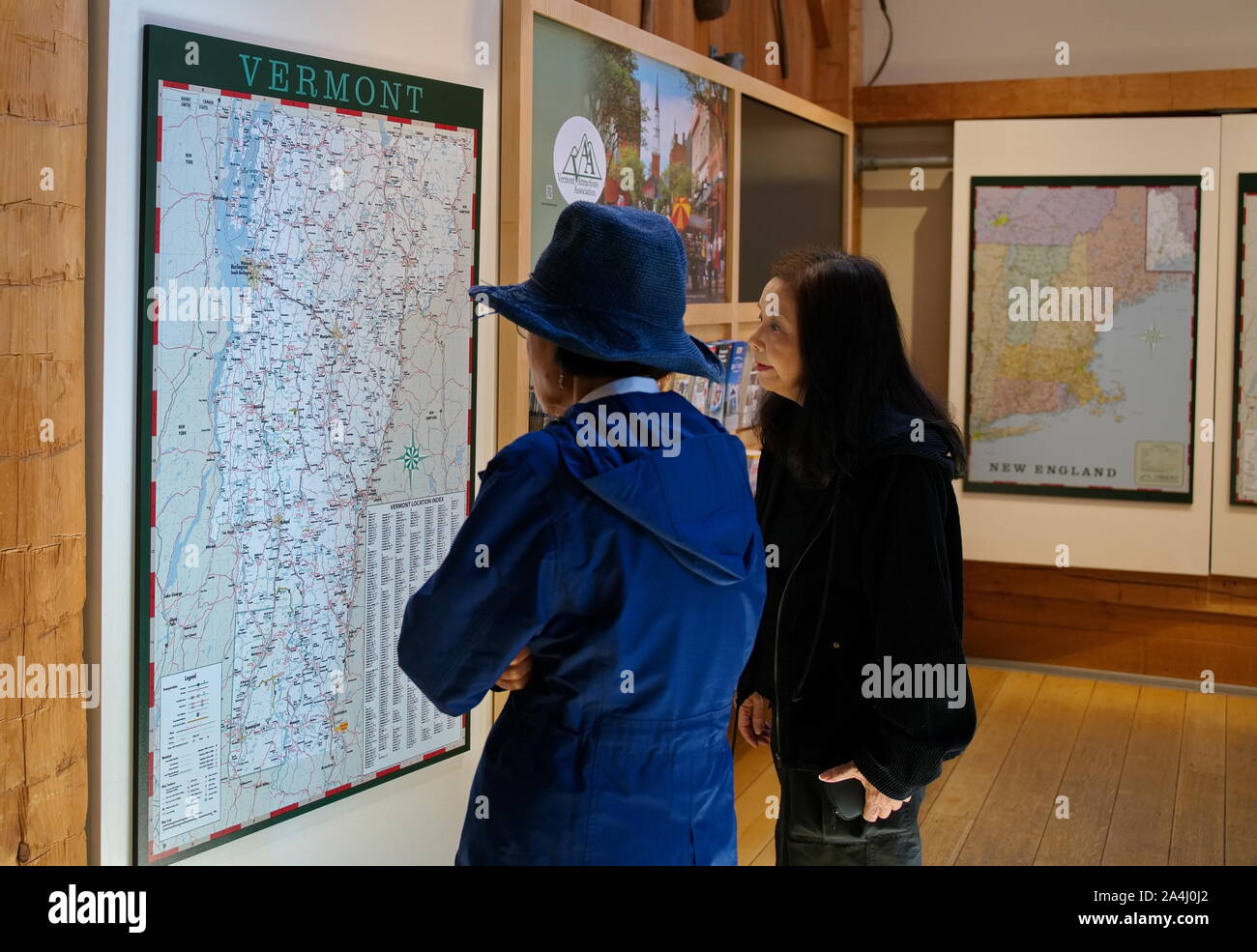Guilford, VT USA. Jul 2019. Asian tourists looking at a Vermont state map at an interstate rest area. Stock Photo