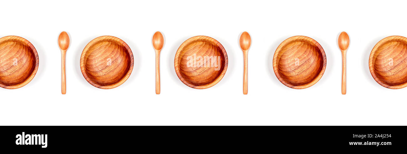 Top view of handmade empty wooden bowls with wooden spoons isolated on white background. Street food and zero waste concept. Stock Photo