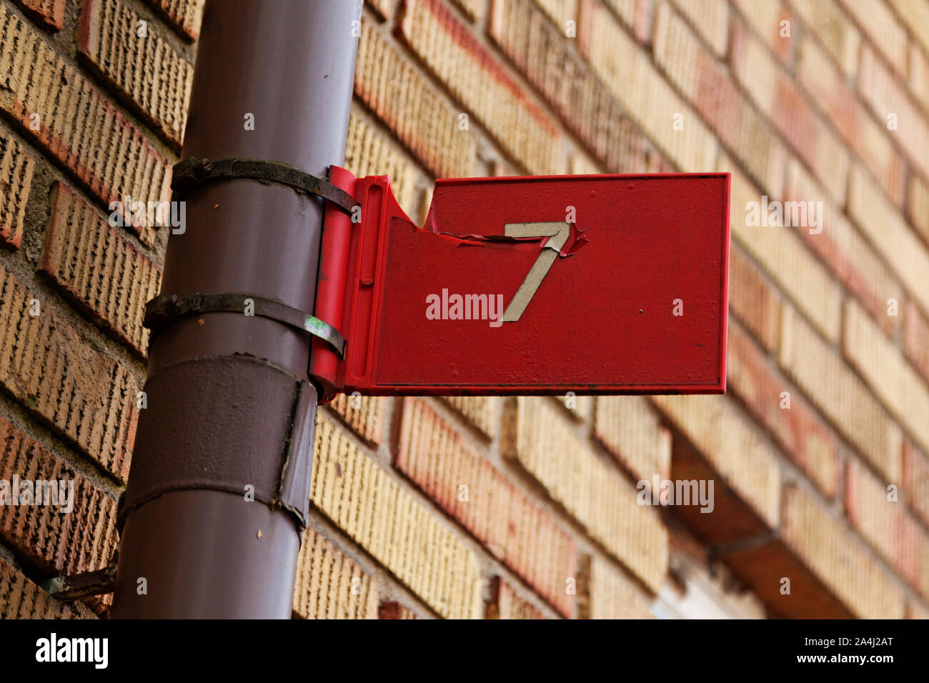 the seven digit with white text on red background as signboard mounted