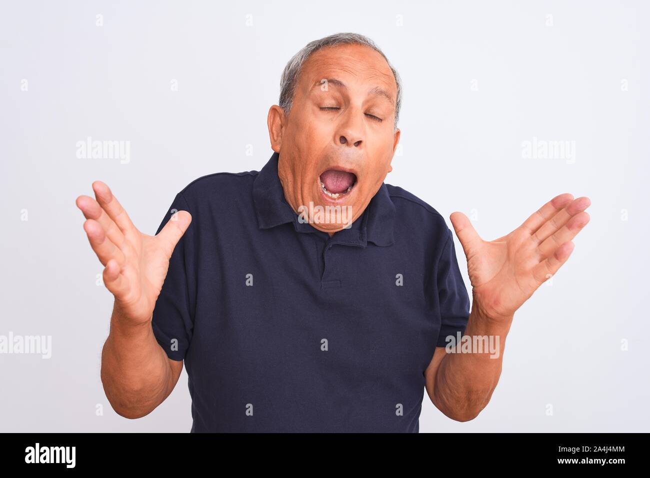 Senior Grey Haired Man Wearing Black Casual Polo Standing Over Isolated White Background