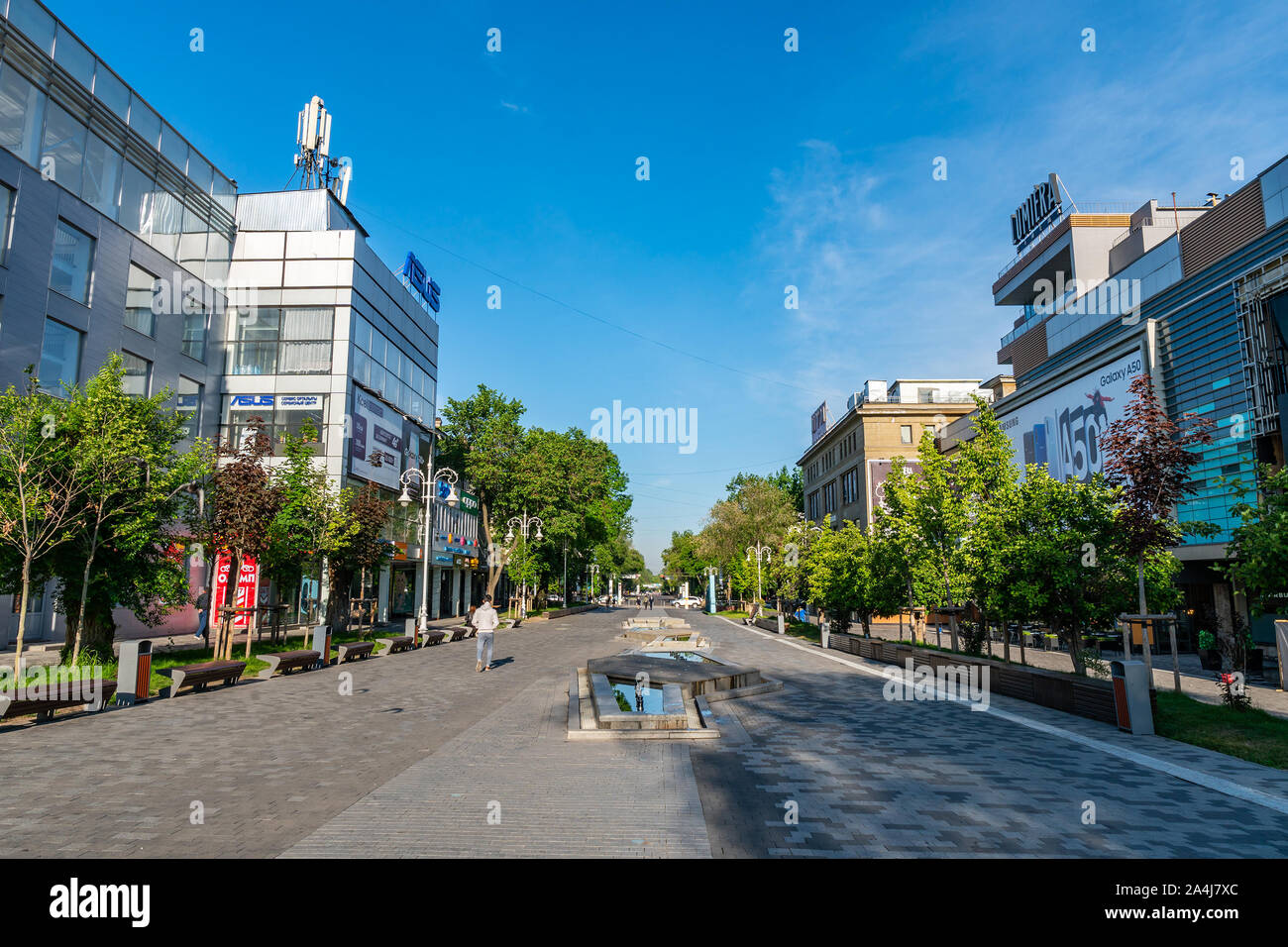 Almaty Zhibek Zholy Walking Street with Closed Stores Shops and Few People Early in the Morning During Sunrise Stock Photo