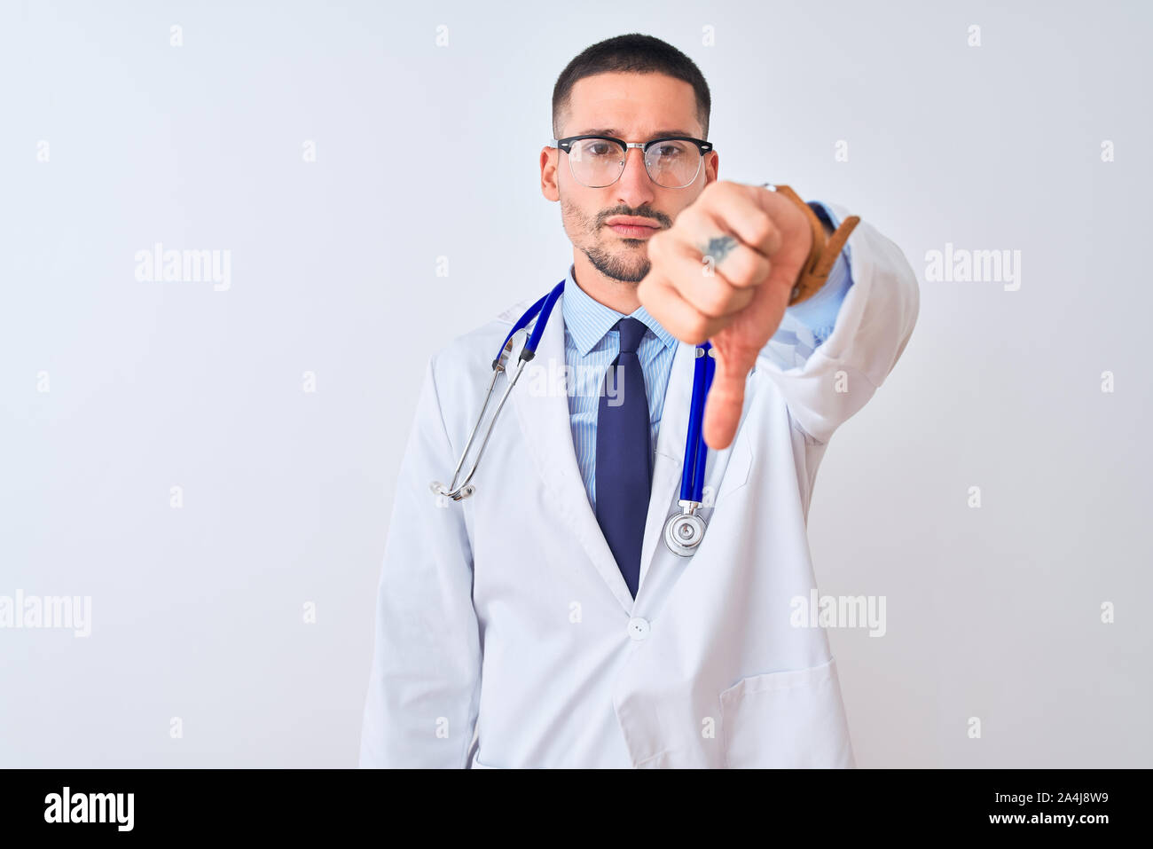 Young doctor man wearing stethoscope over isolated background looking ...