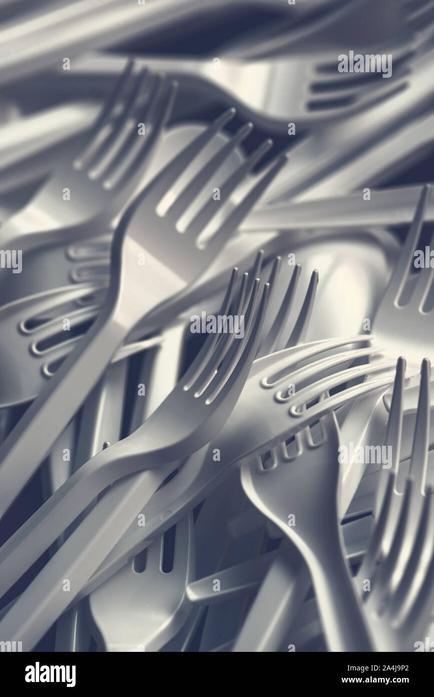Plastic forks scattered on wooden table, top view Stock Photo