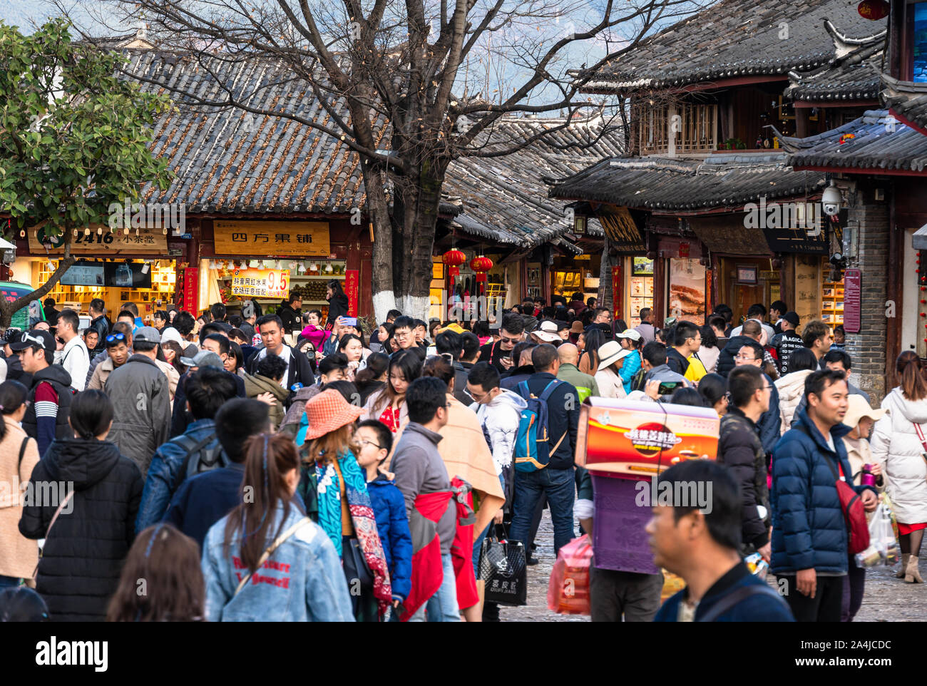 Lijiang, China - February 14 2019: Large number of Chinese tourists wander the street of the famous Lijiang old town in Yunnan province. The place get Stock Photo