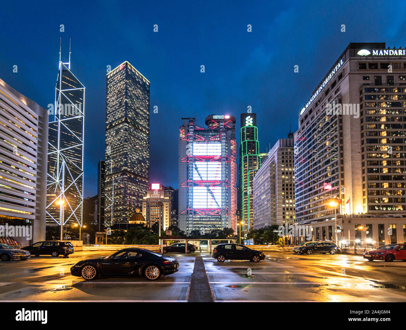 Hong Kong - China - July 4 2019: Luxury sport cars parked on a rooftop parking in Hong Kong Central business district with major bank office building Stock Photo