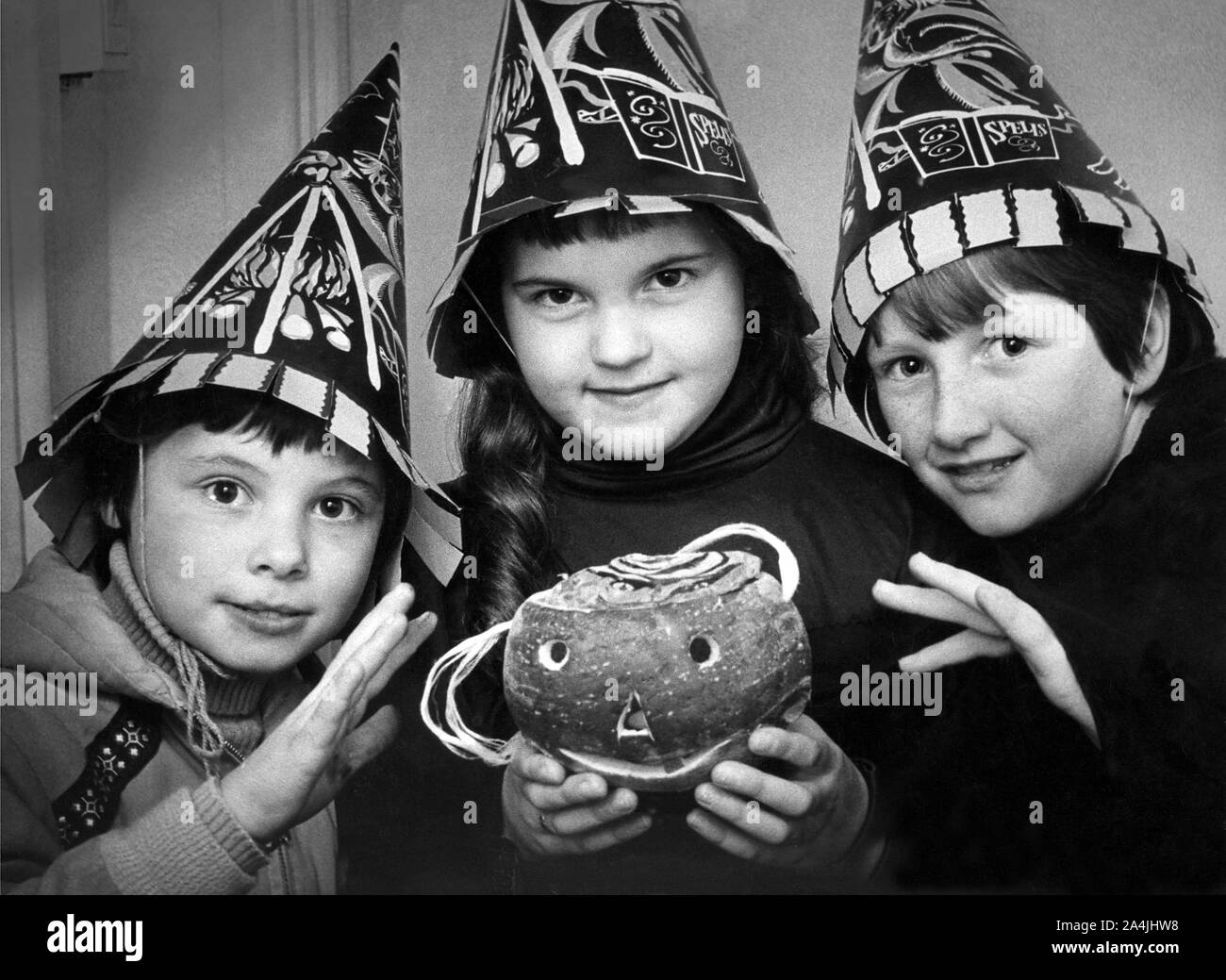 Three children in costume with a turnip lantern for Halloween in October 1979 Stock Photo