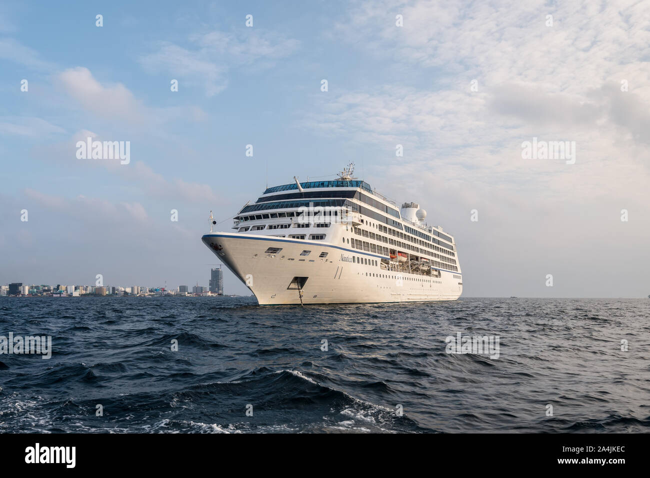 Male, Maldives - November 17, 2017: Oceania Cruises Nautica Cruise Ship is anchored in the outer harbor of Male island as seen from the boat in Maldiv Stock Photo