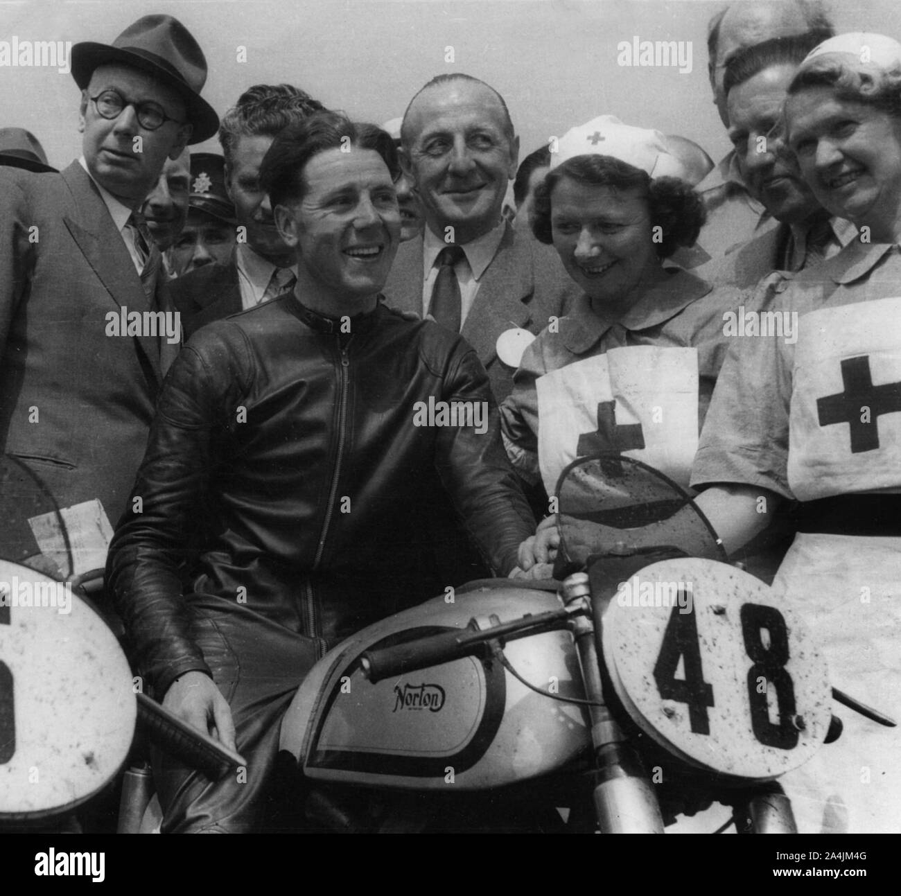 Geoff Duke on Norton, with nurses after race in 1951. Stock Photo