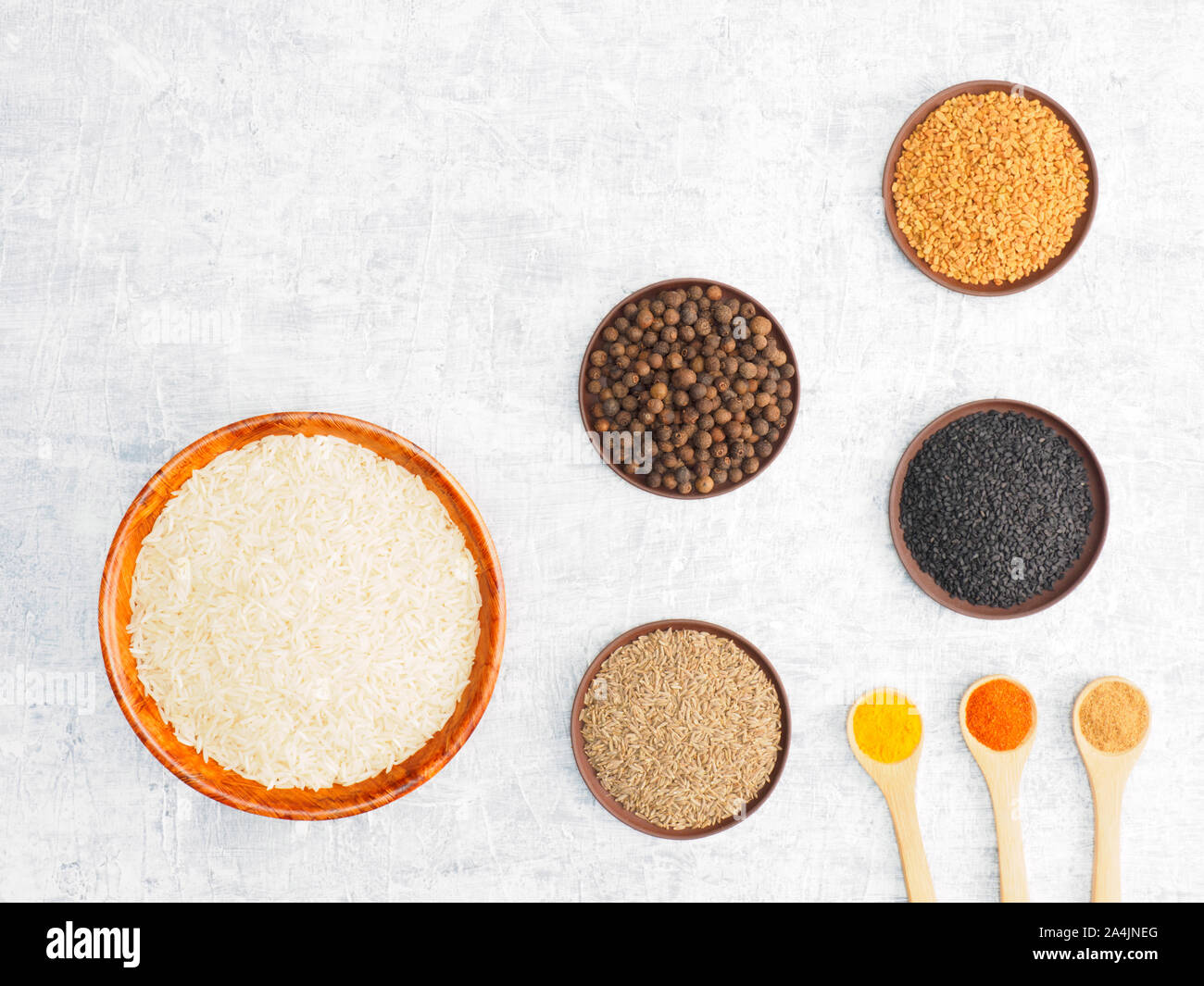 Spices set and rice on white concrete background with copy space ...