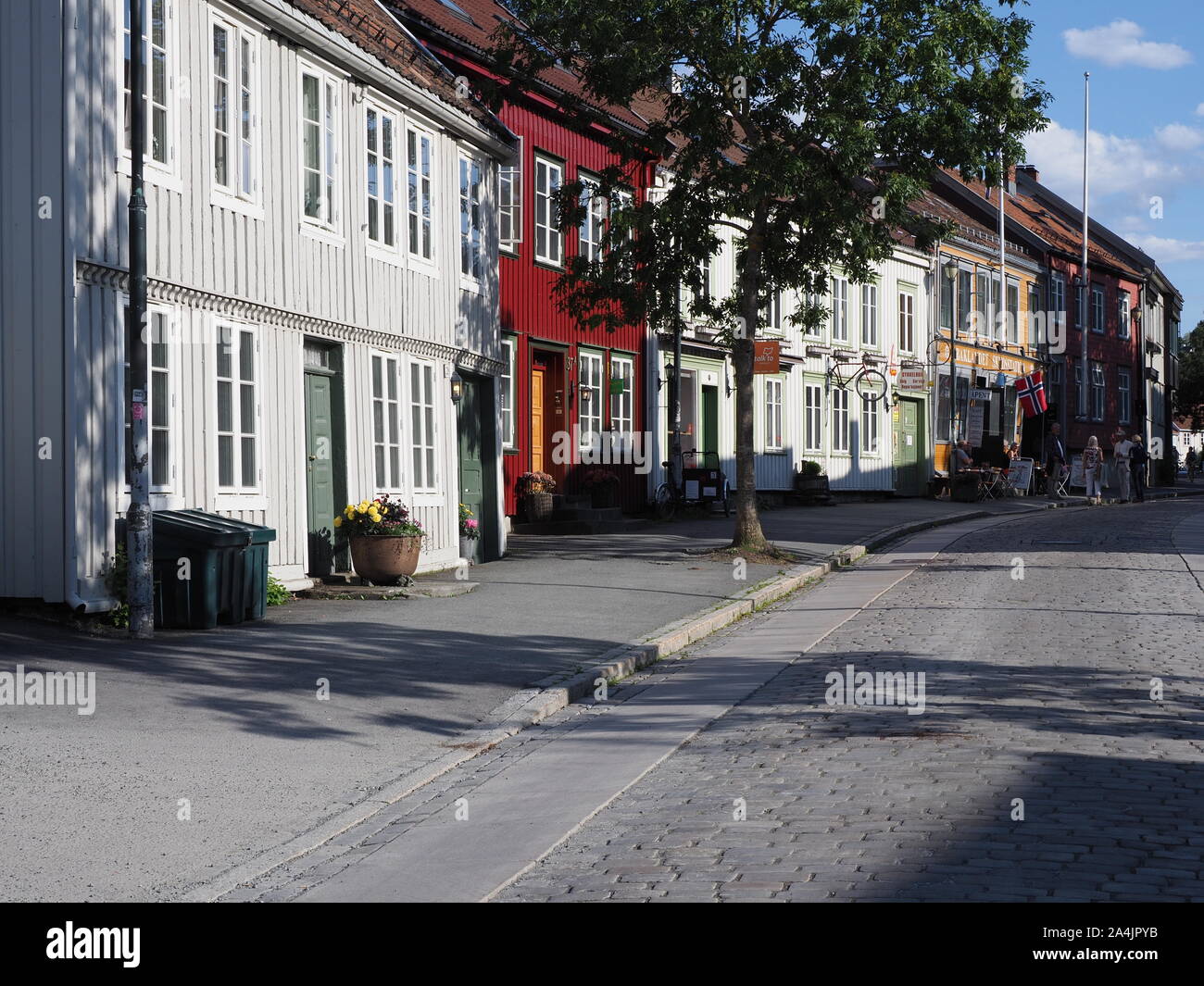 TRONDHEIM, NORWAY on JULY 2019: Narrow street with old colorful wooden houses in european Nidaros city at Trondelag district with clear blue sky in wa Stock Photo