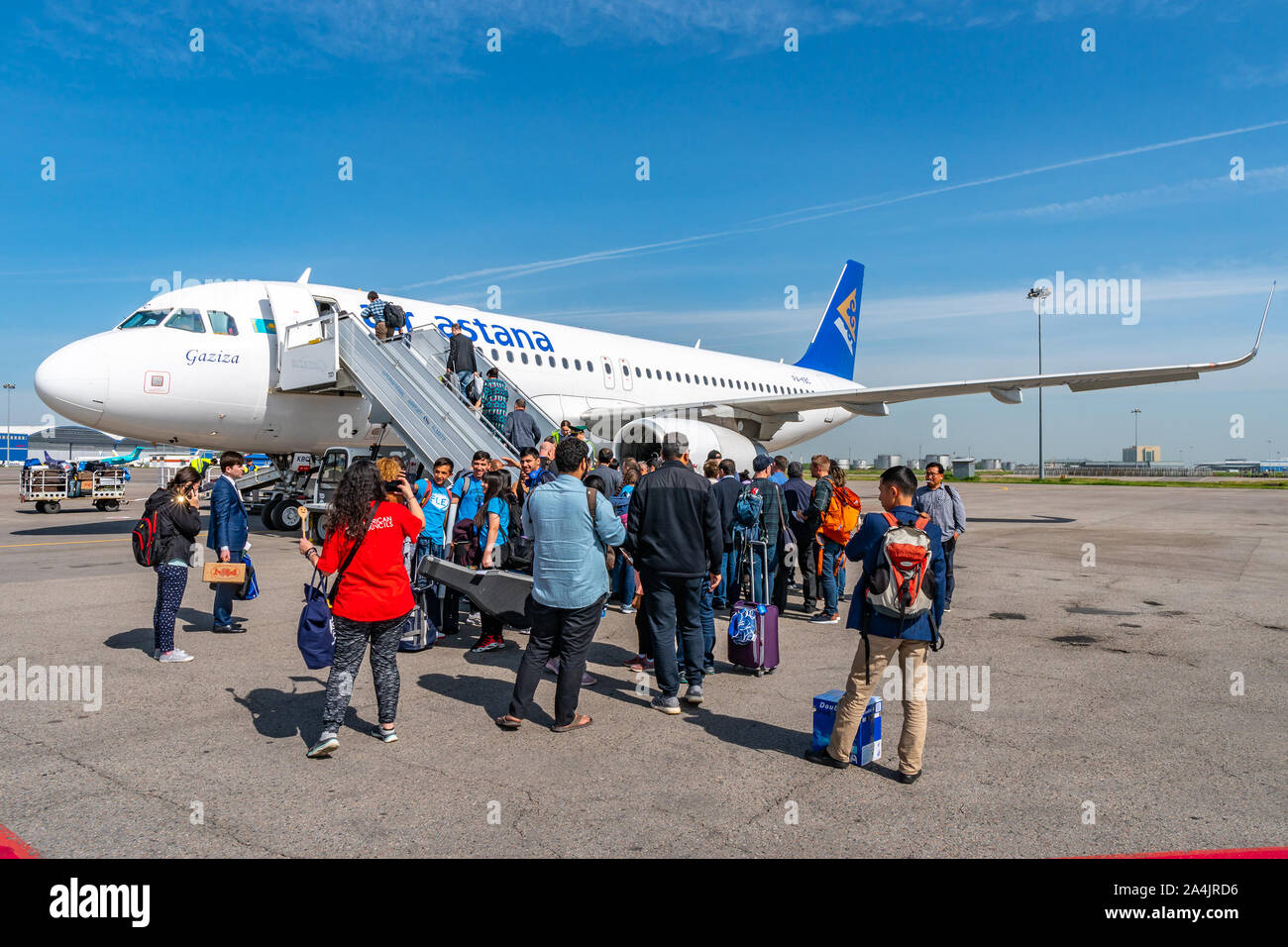 At Almaty International Airport Passengers are Waiting Outside for Boarding the Air Astana Aircraft Plane Stock Photo