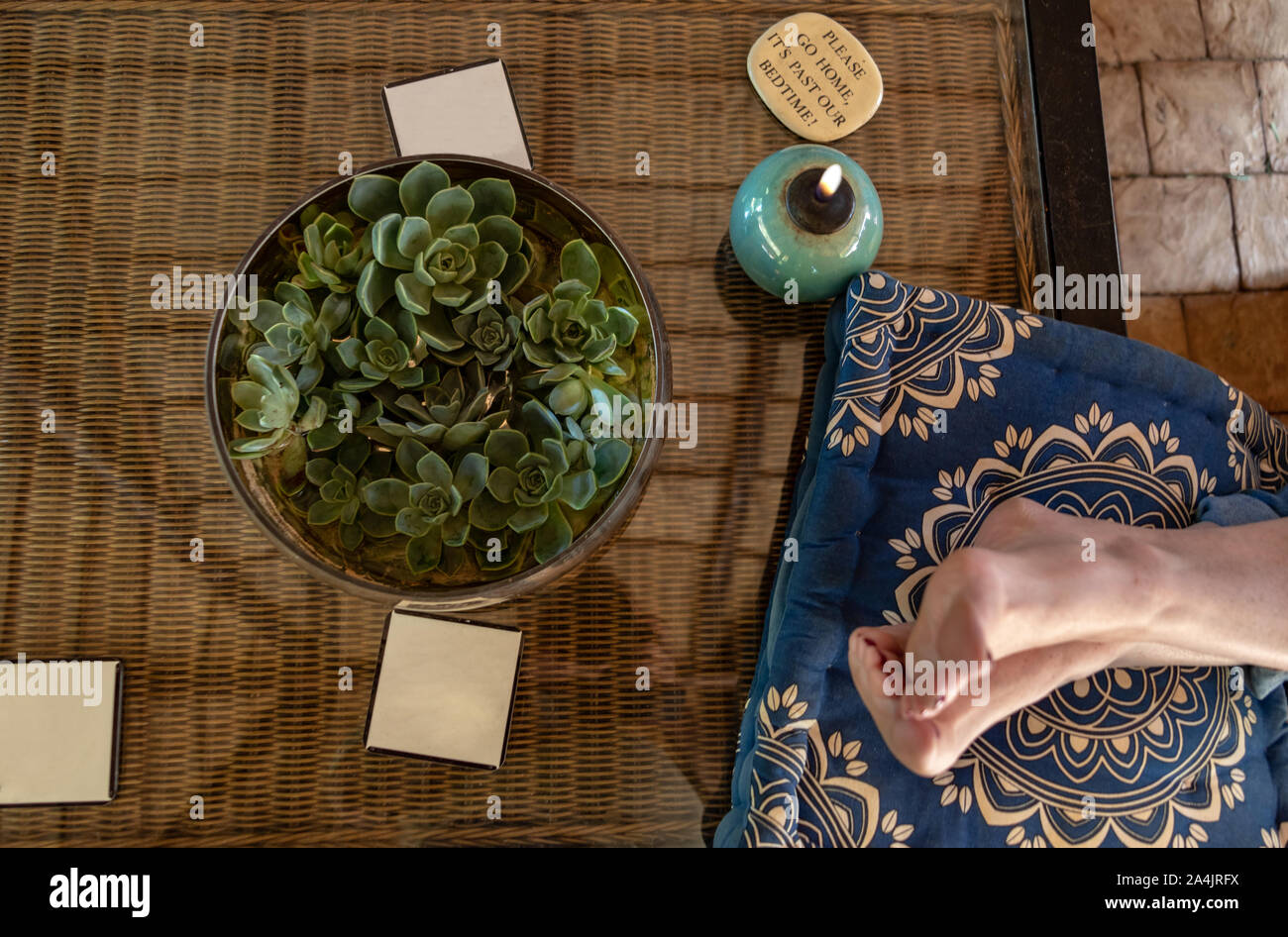 Woman relaxing on the patio with the legs on the table. Stock Photo