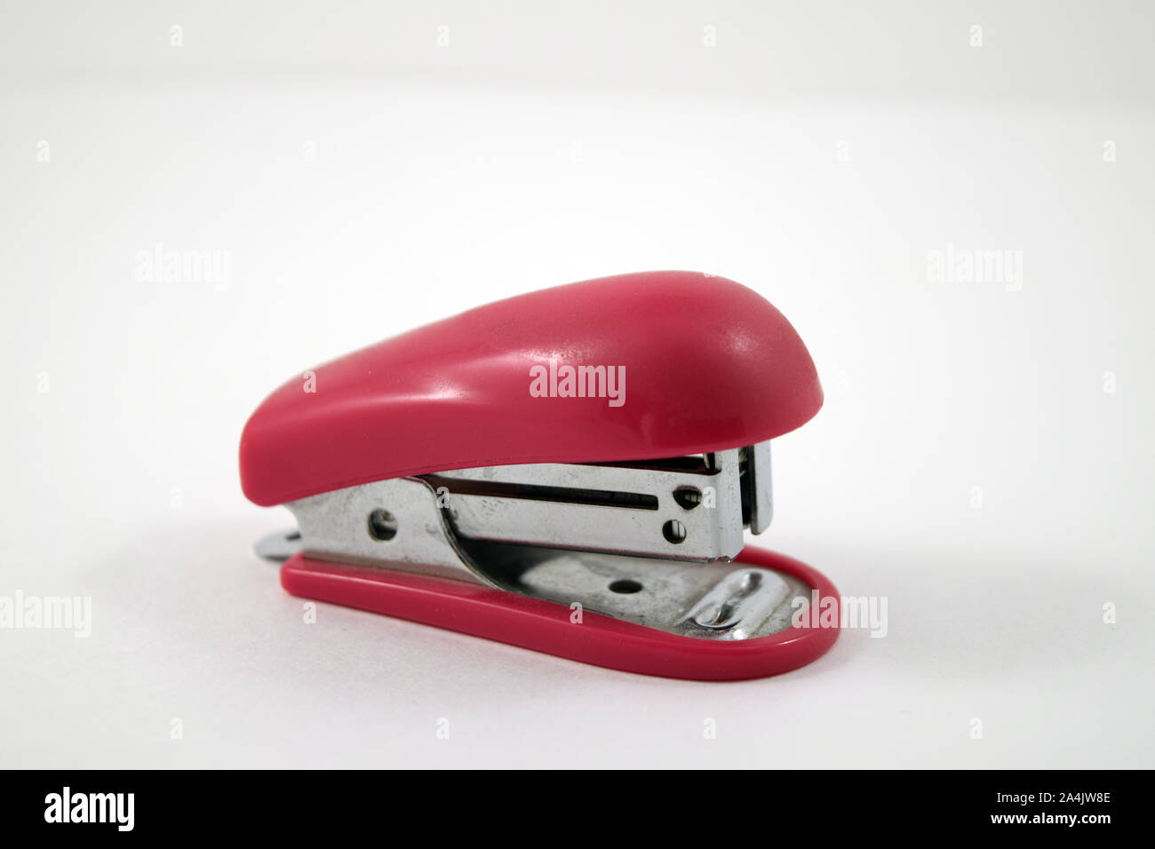 Pink Stapler isolated on white Stock Photo