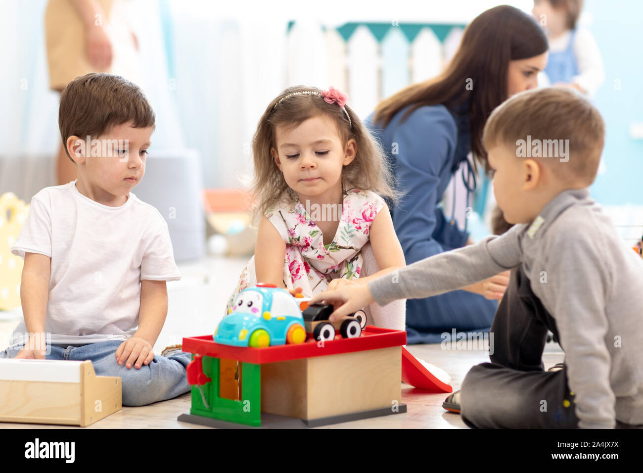 Cute little children playing toy cars in kindergarten Stock Photo - Alamy