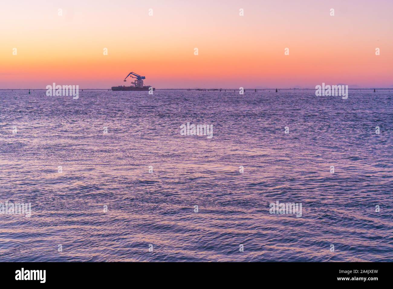 Sunset over the Venice lagoon with a ferry Stock Photo - Alamy