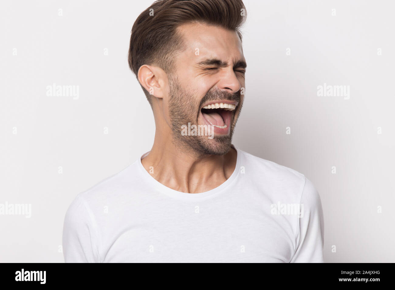 Furious caucasian man feel displeased yelling loudly Stock Photo