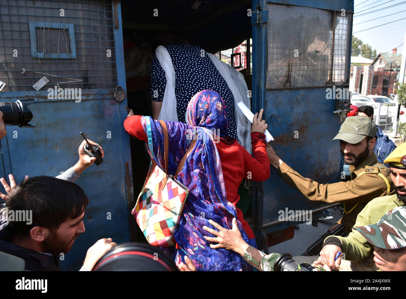 Government forces detain protesters during the demonstration.Women of Kashmir hold a protest against the abrogation of Article 370 by central government which grants special status to Jammu & Kashmir. Stock Photo